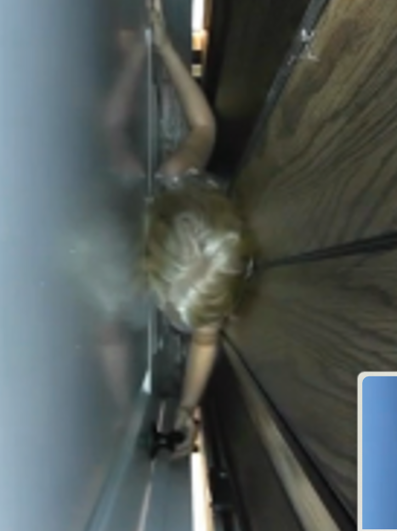 A seven-year-old child in the space with the landing door and elevator door closed
