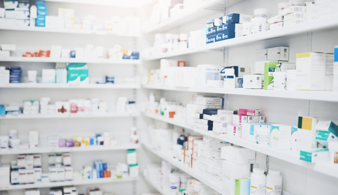 Shelves in pharmacy filled with boxes of medication. 
