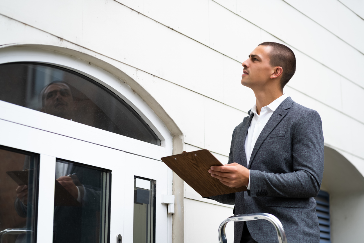 Property Appraisal. Man Inspecting Building. 

