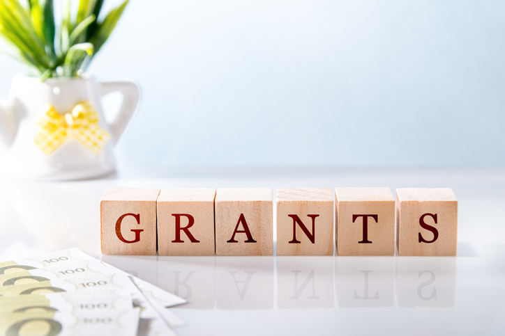 Picture of the word Grants in wooden blocks on a glass desk. 