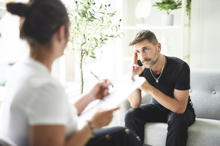 A man with psychologist discussing drug addiction. 