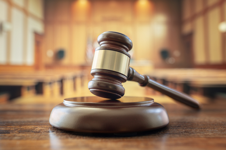 Judges gavel in court room legal trial and law background.