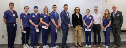Marquette University School Dentistry full height group photo. Most are in dark blue scrubs.
