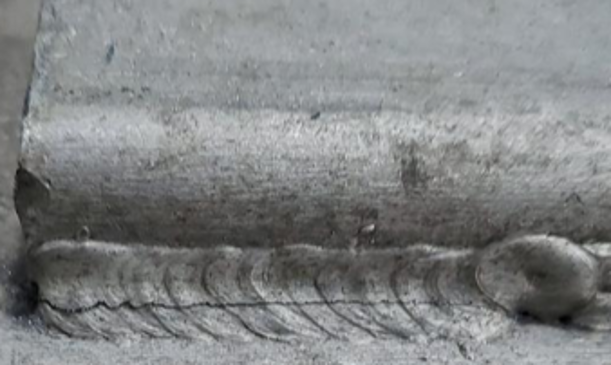 Weld with a crack forming along the direction of the weld.