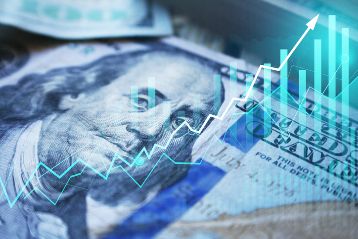 Image of the dollar with a line graph and bar graph moving up. 