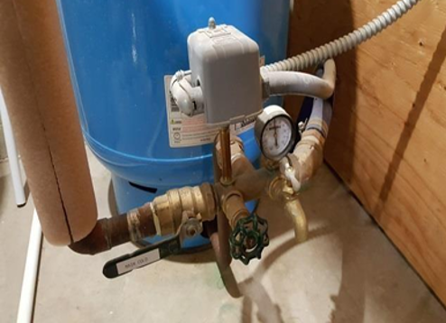 Water Well Pump Valve. The Pump is Blue and the handle on the pump says Main Cold.