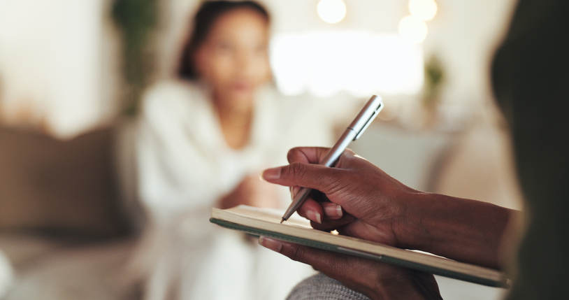 Woman psychologist counseling patient documents compliance questions, and captures information. 