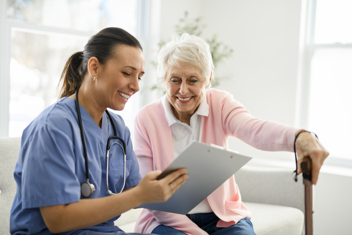 A portrait of a young nurse with a senior patient during a consultation. 