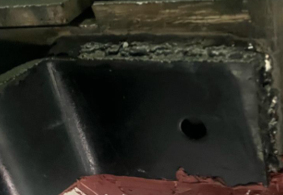 Weld that has developed holes in the line of welding.