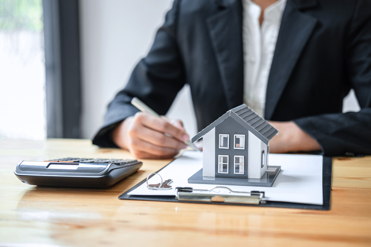 Real estate agent working sign agreement document contract for house insurance. 