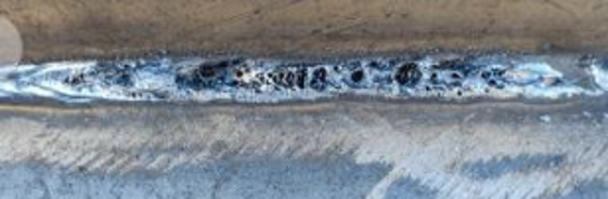 Weld that has developed holes in the line of welding.