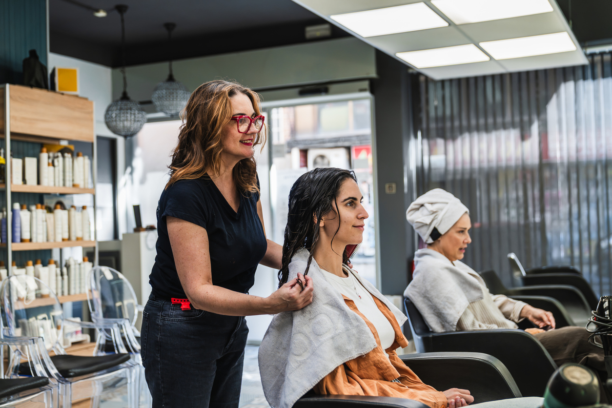 Cosmetologist consulting on client's hair


