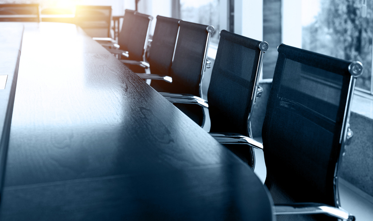 Image of a Board Meeting Room with Empty Chairs. 