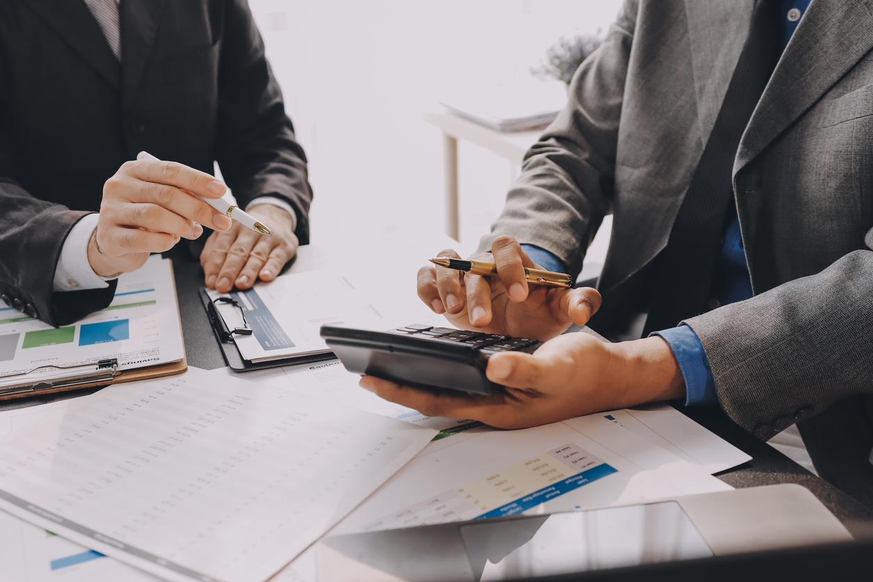 Accountant team working in office, analyze financial data and accounting record with calculator. 