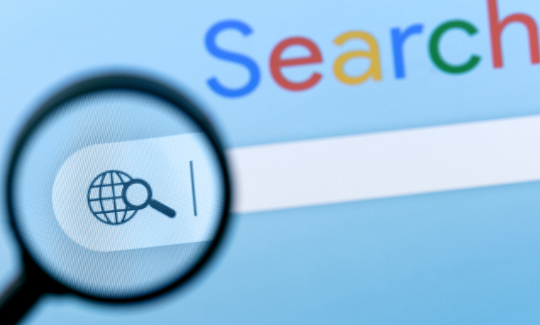 Internet browser search bar with magnifier on computer screen with text describing the word Search.

