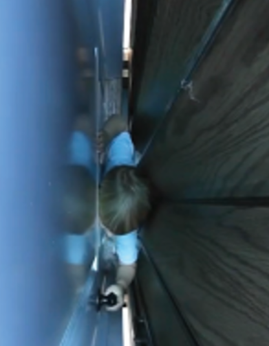 A four-year-old child in the space with the landing door and elevator door closed
